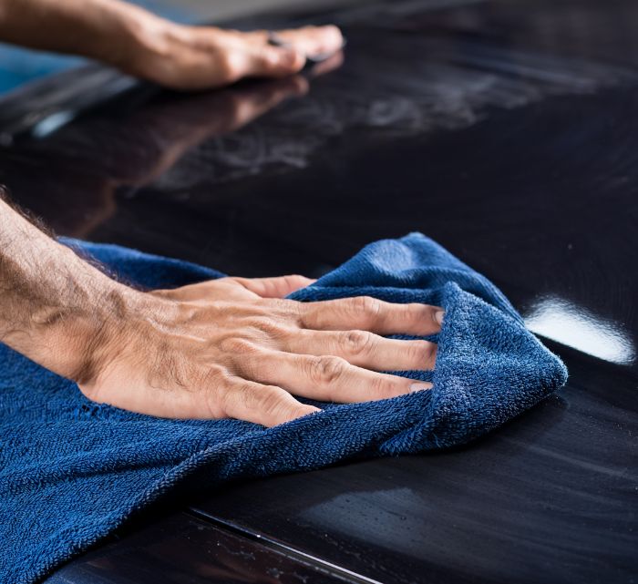 A polished, glossy surface with water beading on it